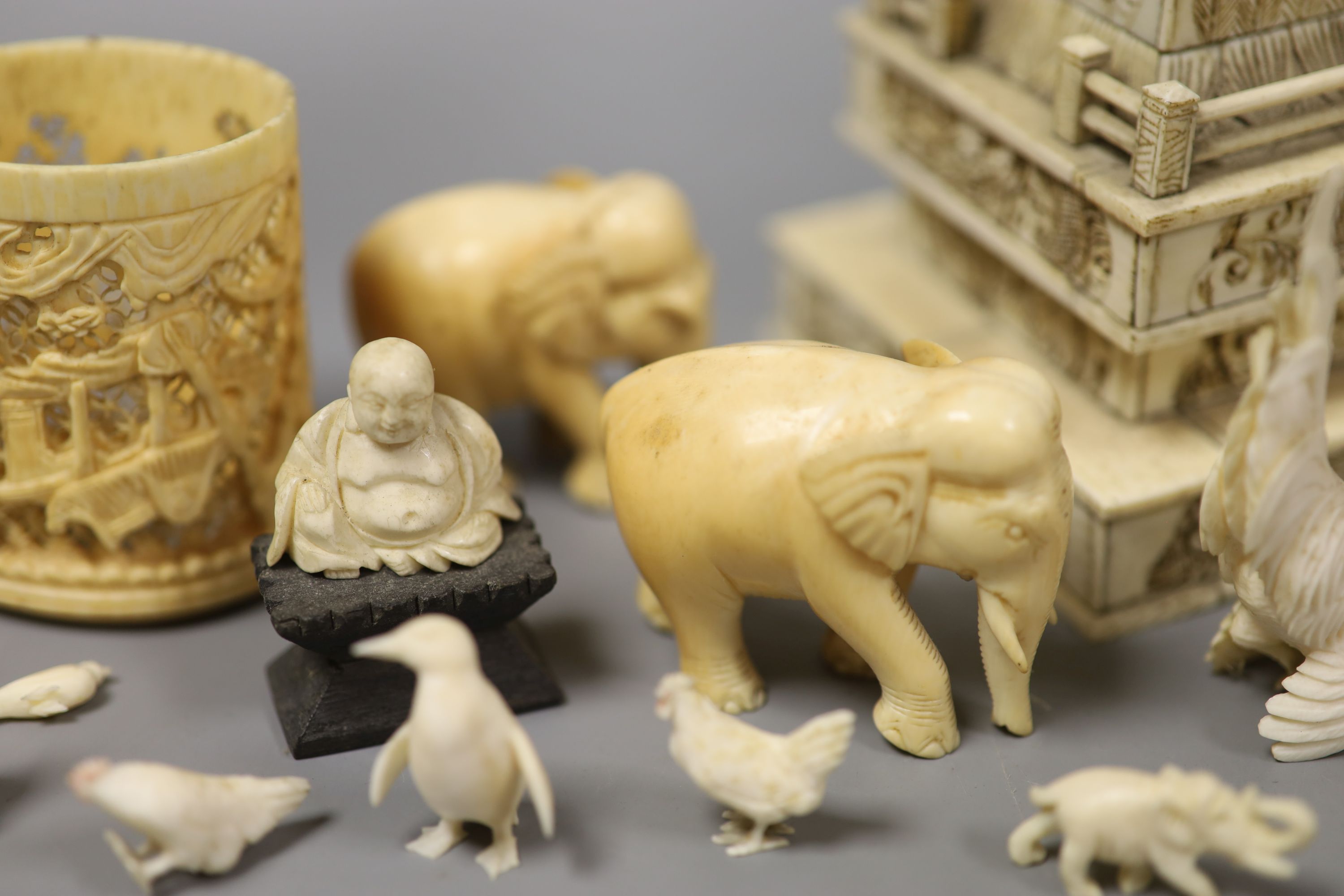 A Japanese Ivory model of a bijin, a similar model of a temple, various European Ivory models of animals and birds, an Indian Ivory figure et cetera, or late 19th or early 20th century